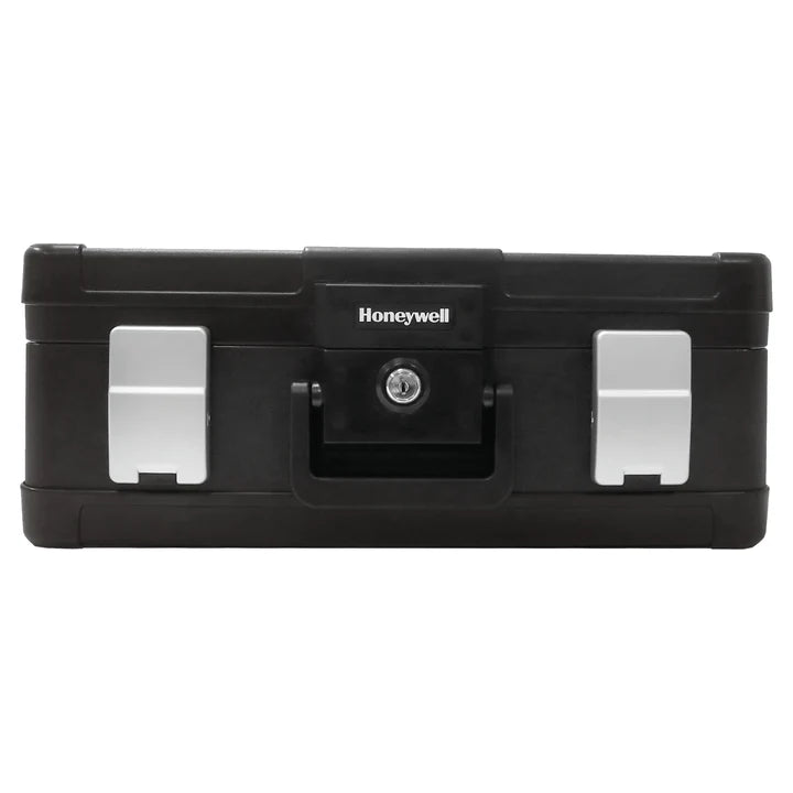 Woman sitting at a kitchen table with a large black Honeywell 1114 Fire & Water Chest in front of her.