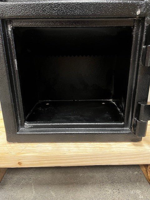 View of the inside of the safe, the safe has four predrilled holes to be able to bolt down the safe. The door trim has a few paint chips as well. 