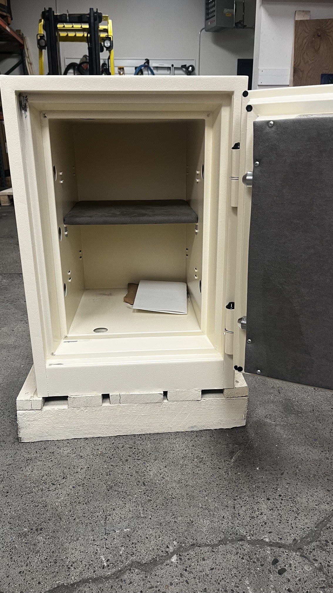 View of the inside of the safe. It comes with one adjustable shelf and one center bolt down hole. 