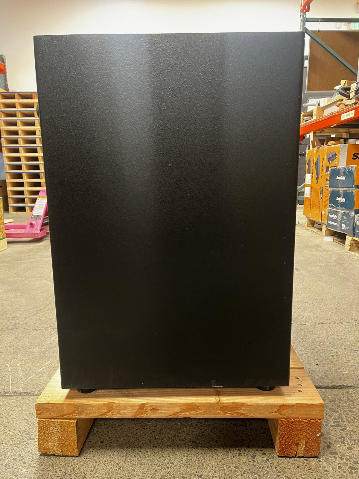 View of the back of the safe. The lower area of the safe has a small scratch. 