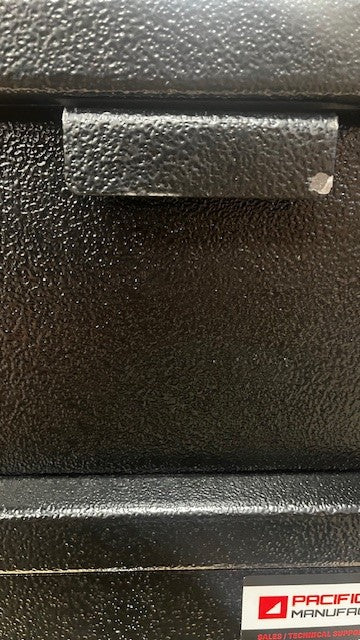 View of the pull-down handle showing the paint chip on the right side of the handle and lower edge of the handle. 