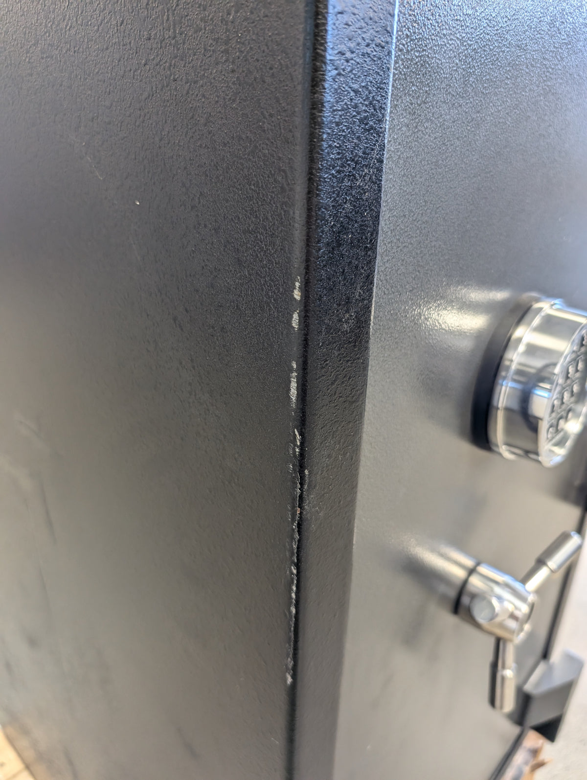 Blemished American Security BFS3416E1 left side scuffing and paint damage on front edge of safe. 