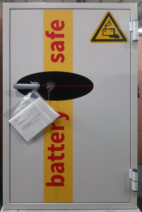 Metal cabinet labeled 'battery safe' with warning signs on a white background