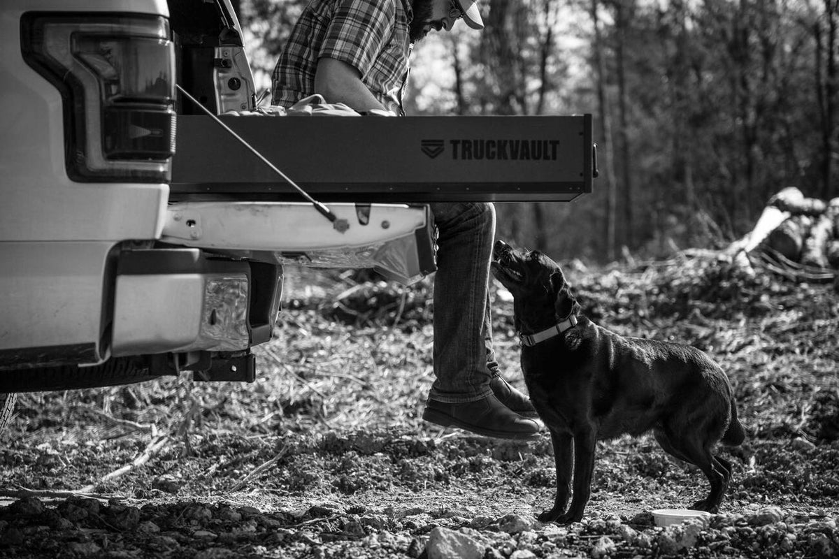 TruckVault with Person and Dog in the Woods