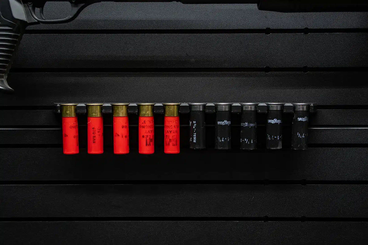 Ammunition with red casings on a black surface