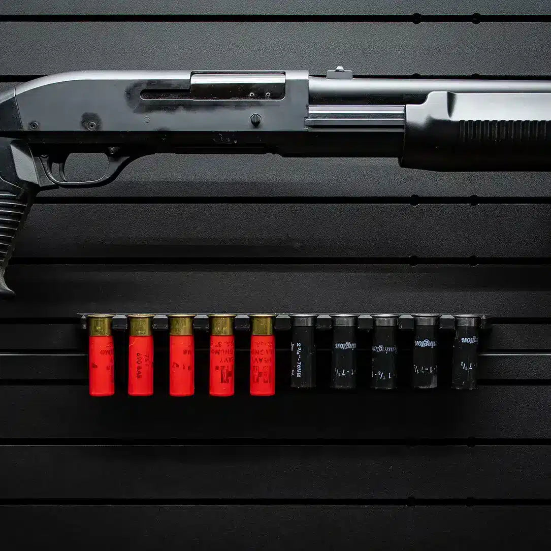 Shotgun with red and black shells on a dark surface