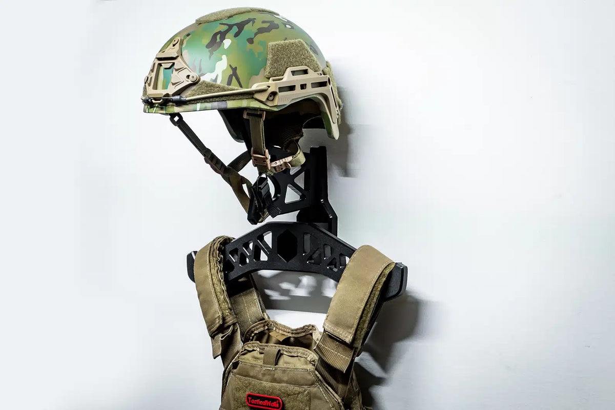 Camouflage helmet and tactical vest on a white background
