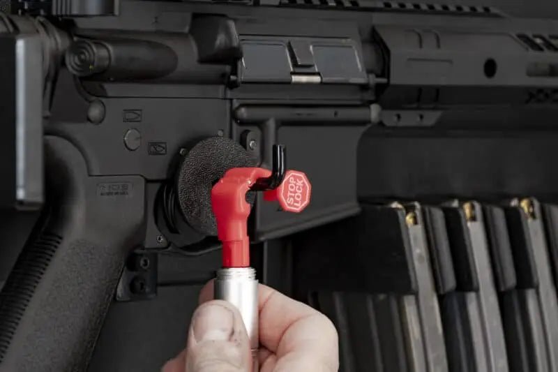Close-up of a rifle with a Tactical Walls ModWall Magnetic Weapon Lock, held by a hand.