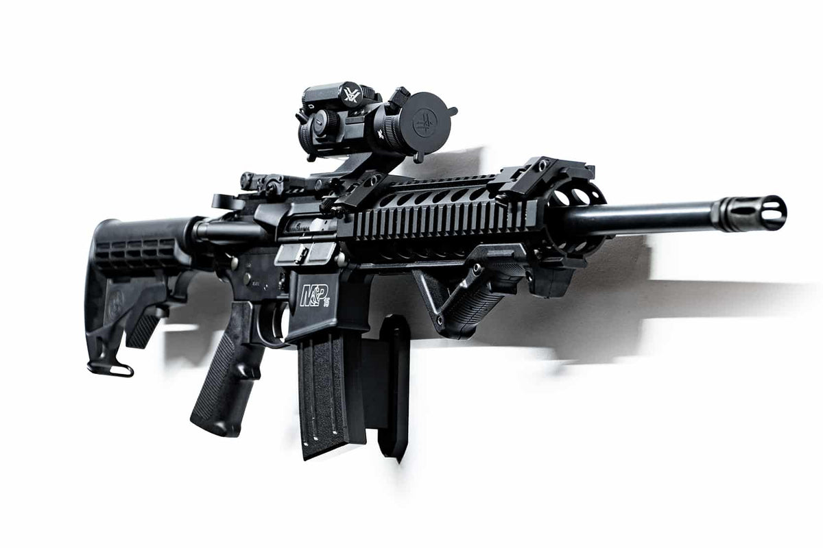 Black rifle with scope on a white background