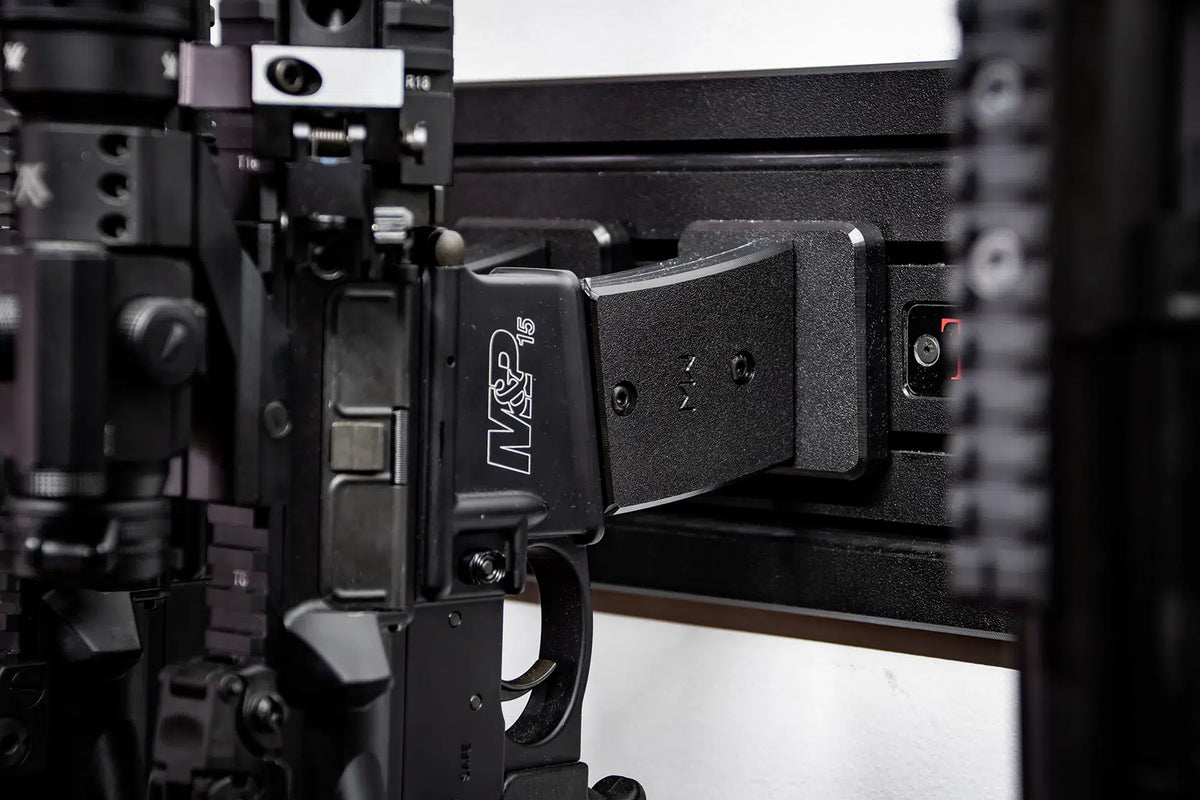 Close-up of a firearm with a magazine attached, featuring the brand 'MP' on the magazine.