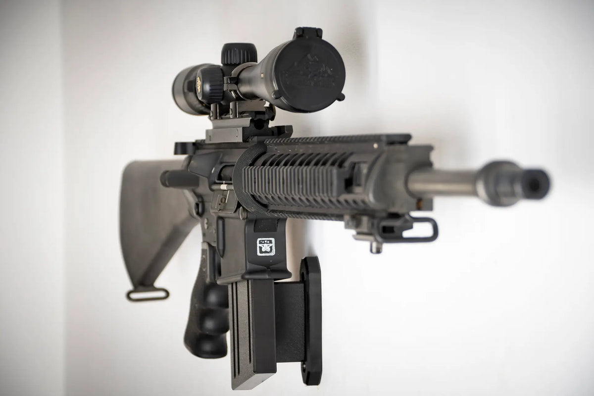 Black rifle with scope on a white background