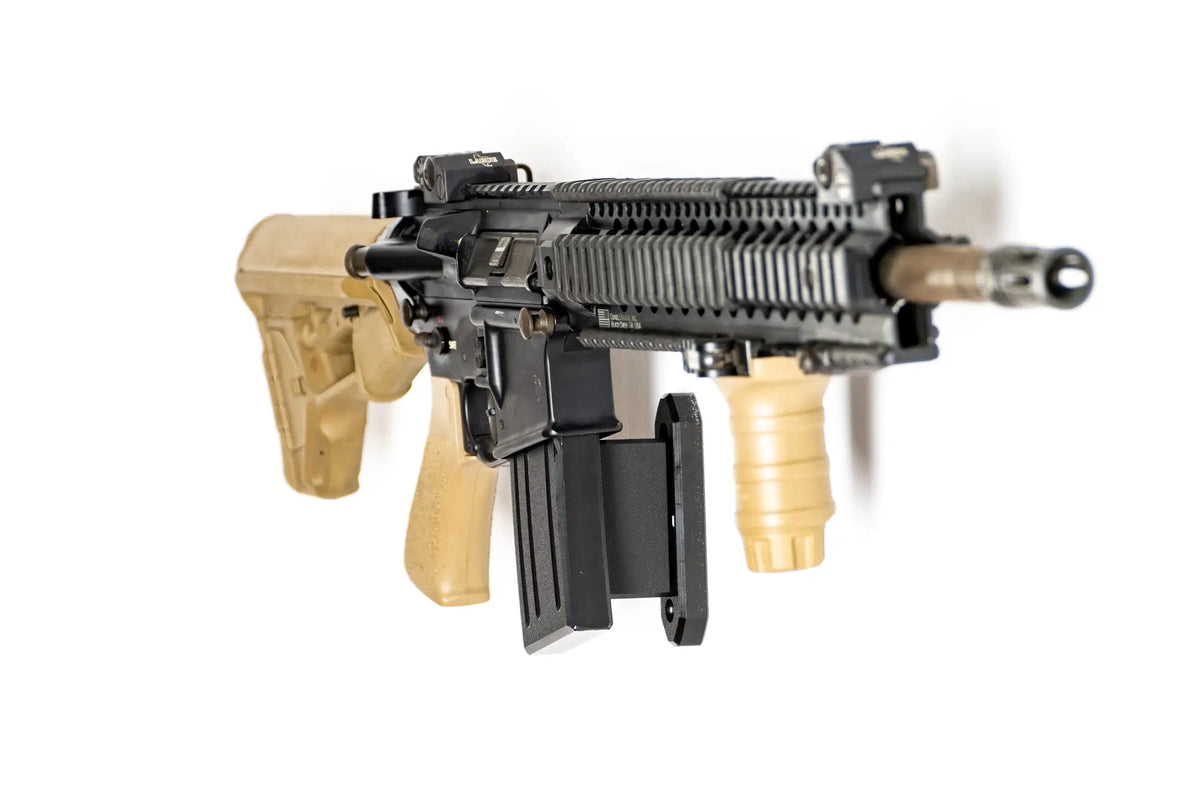 Black rifle with tan stock and grip on a white background