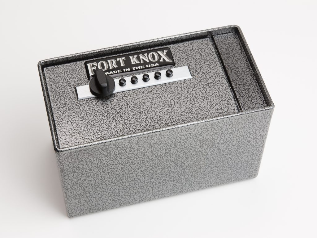 Fort Knox PB4 Personal Pistol Safe shown from a side-back angle in silver hammertone finish, showing the full length of the compact rectangular pistol-box body, Simplex pushbutton lock and turn knob on the pull-out drawer face, and "FORT KNOX MADE IN THE USA" nameplate