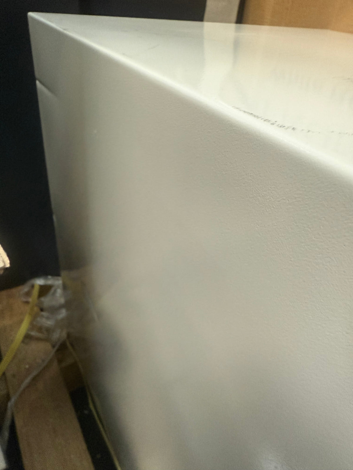 Blemished Hollon HS-610E left side of safe with dents and scuffs visible on side and top. 