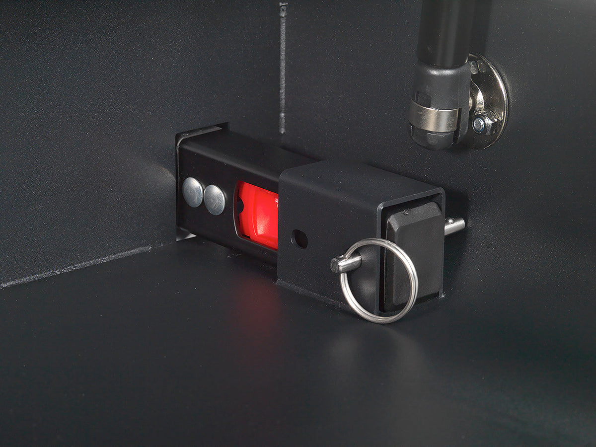 Black security lock with red button on a dark surface