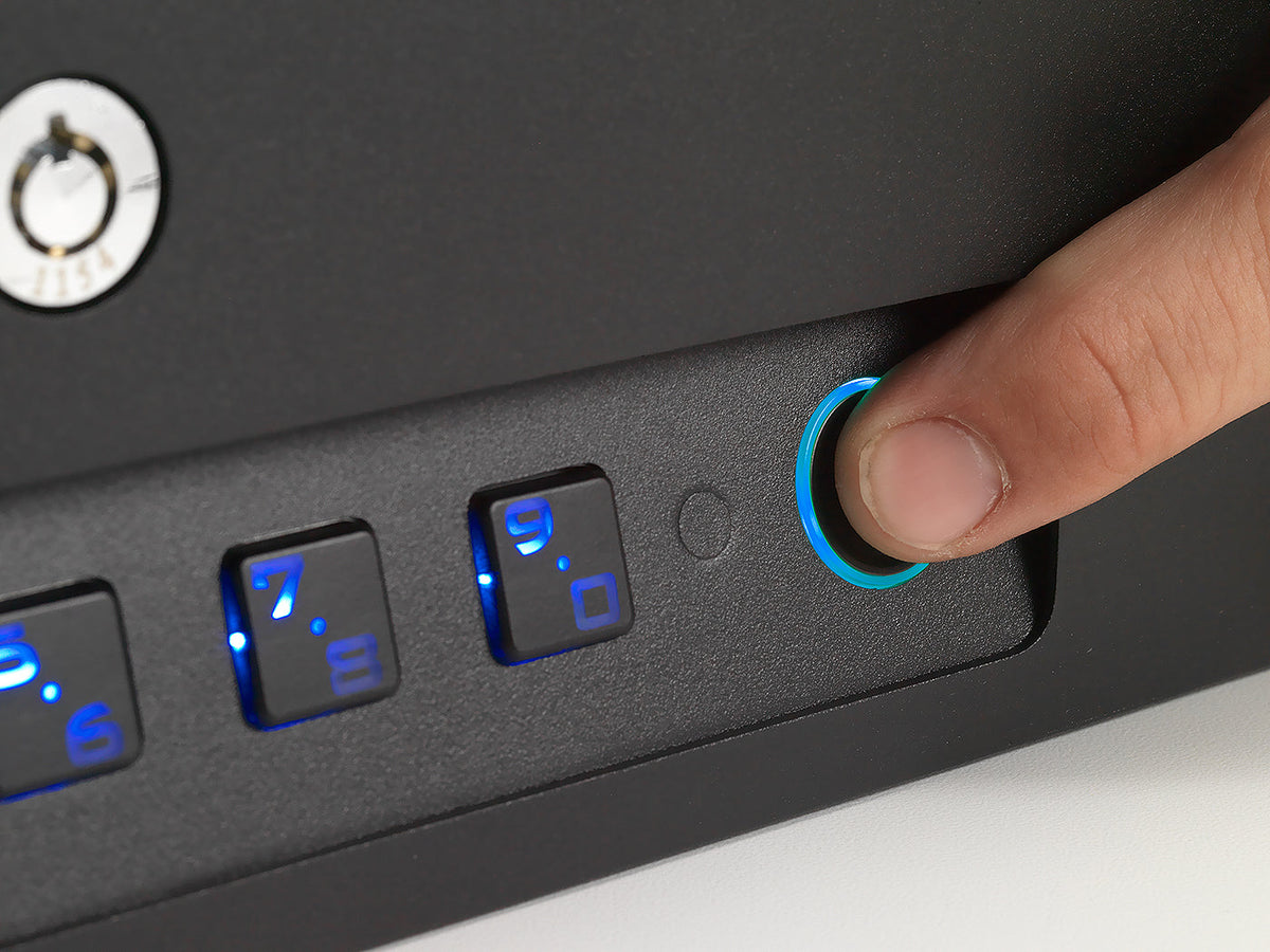 Hand pressing a button on a device with illuminated buttons