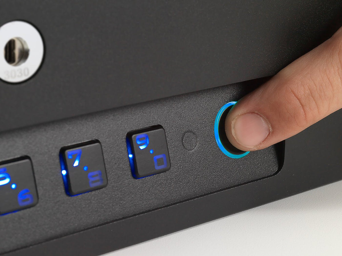 Hand pressing a button on a device with illuminated buttons
