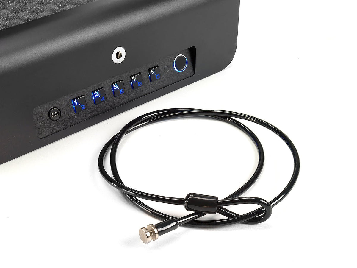 BoostedSafe Elite Vehicle Gun Safe front panel close-up showing blue-lit digital keypad buttons and circular fingerprint sensor, with included black steel cable lock displayed below on white background