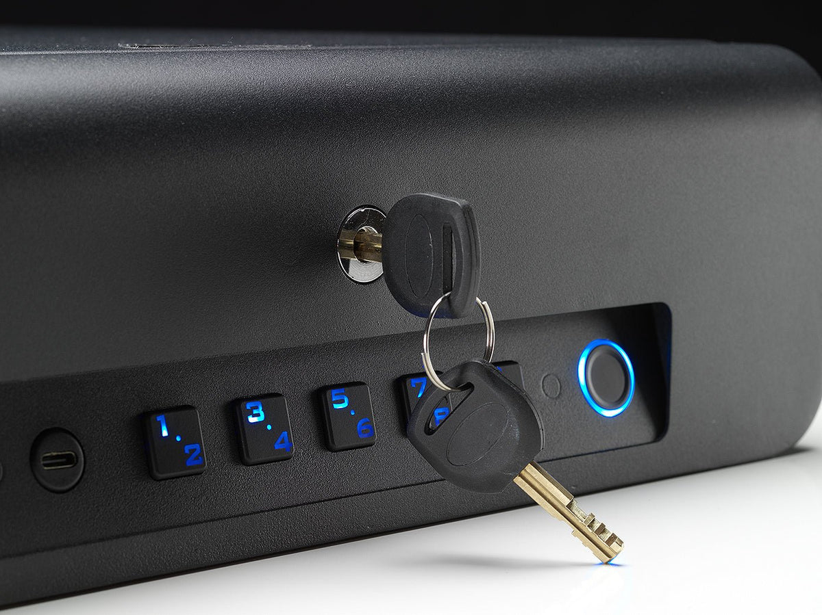 Black electronic device with keypad and keys on a white surface