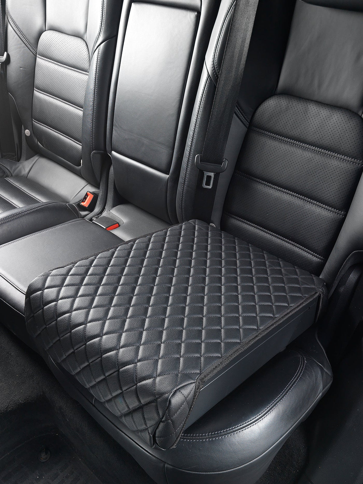 Car seat with a diamond-patterned black seat cover