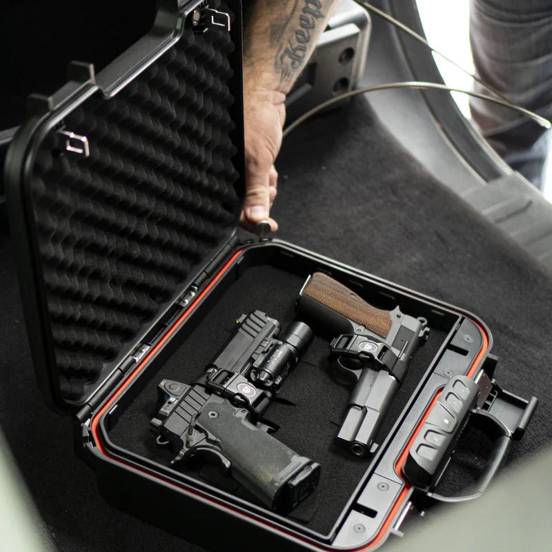 Vaultek LifePod XE open in a vehicle with two handguns and security cable tethered for in-car concealed carry storage