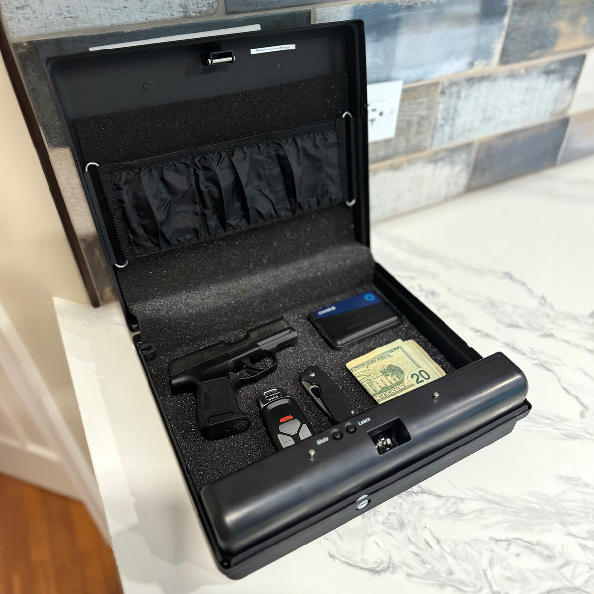 GunVault MV1050-19 MicroVault XL Quick Access Handgun Safe Open on Desk with Handgun & Misc Items