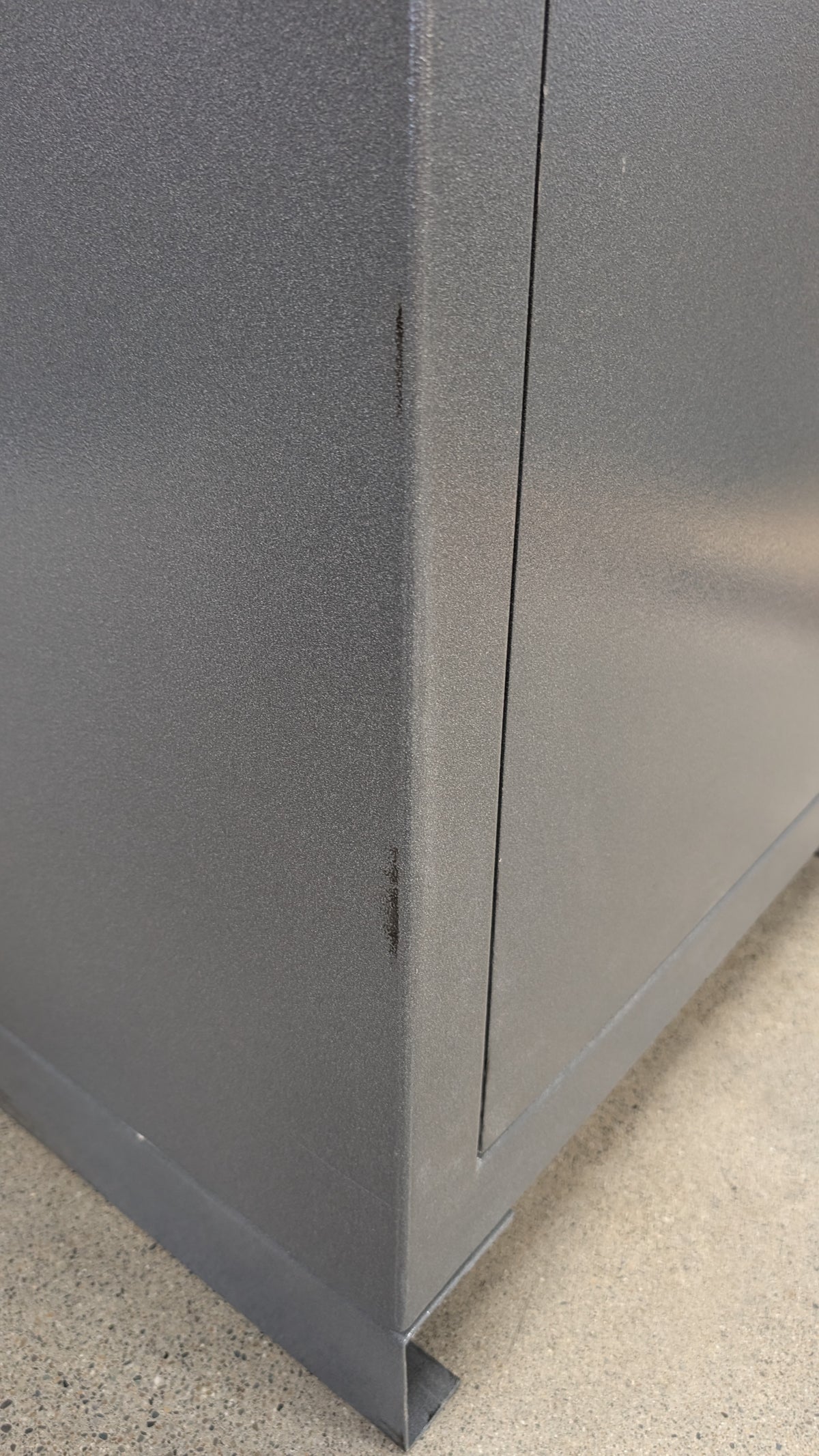 Blemished AMSEC NF6030E5 paint scuffs on left side of safe towards front edge. 