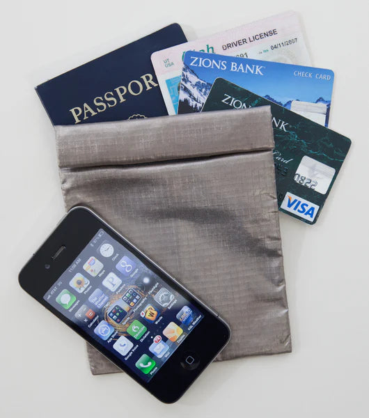 Phone, passport, driver's license, and cards on a gray fabric surface