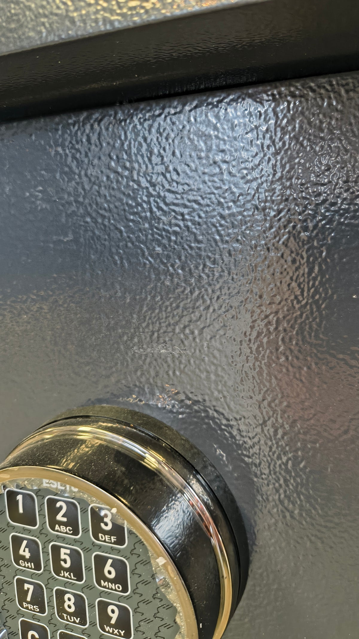 Blemished AMSEC WS1214E5 scuffing near lock. 