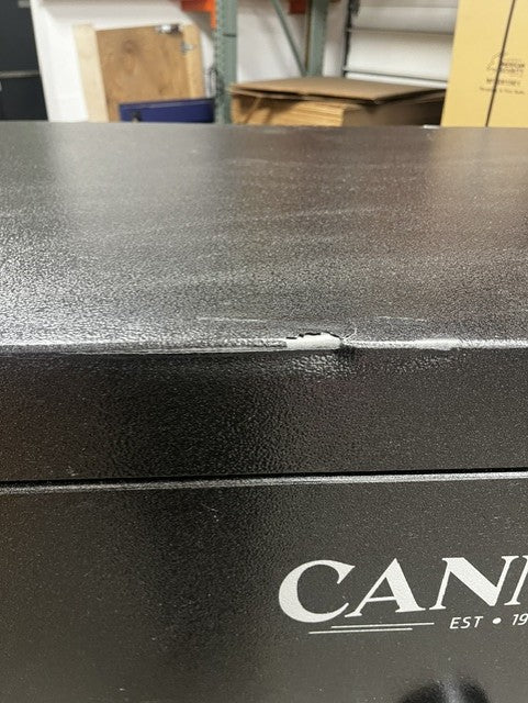 Close-up view of the top edge where the dent is and where the paint has a chip. 