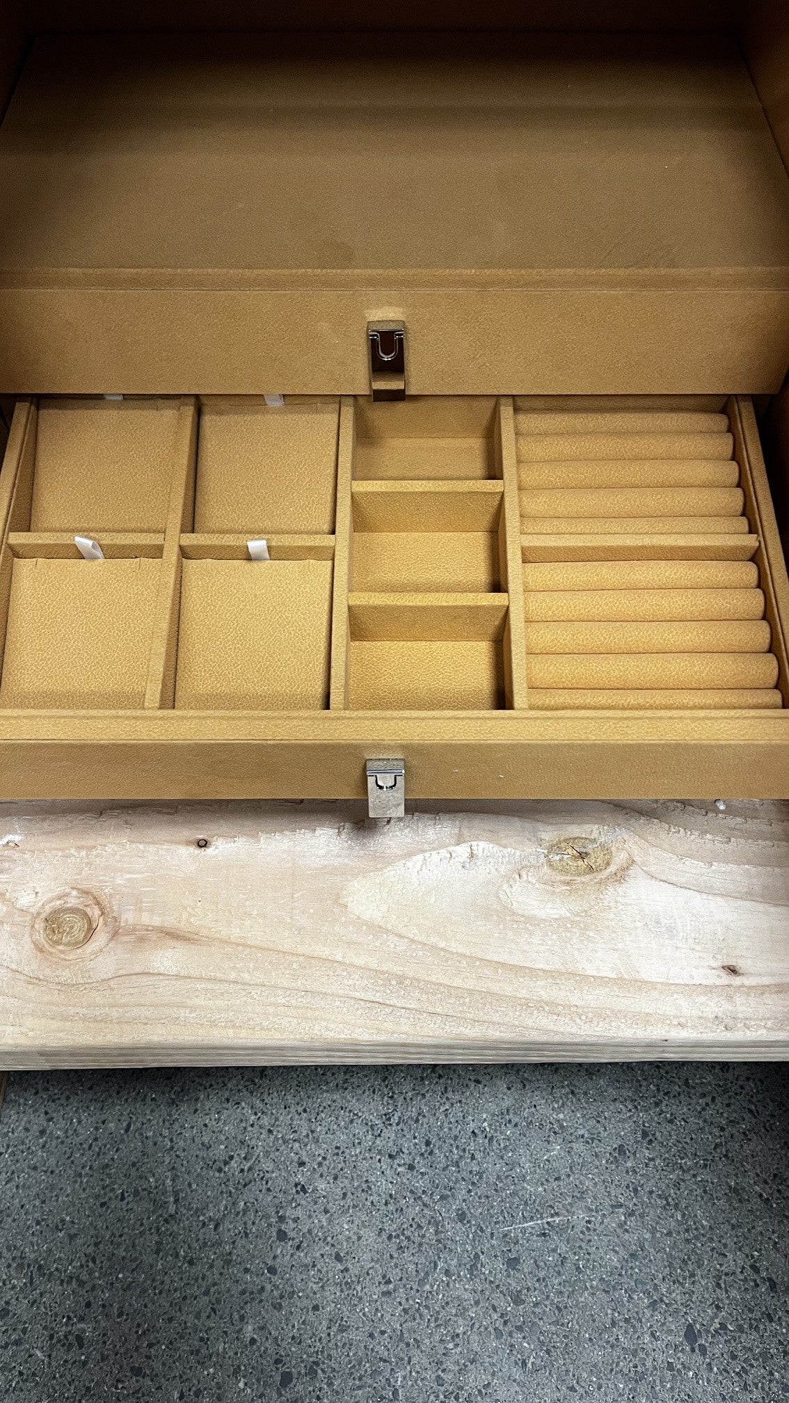 View of the bottom jewelry drawer. It has space for rings, earrings and small necklace.  