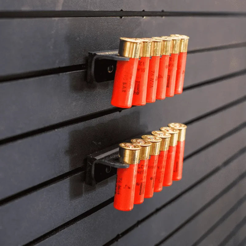 Red shotgun shells with gold caps on a black slat wall