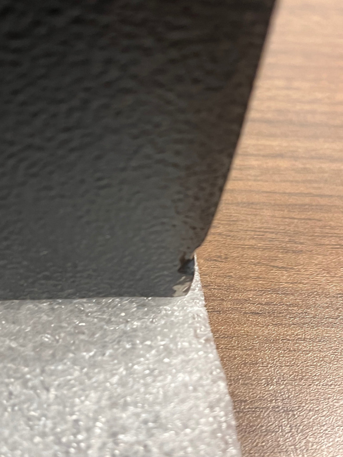 Bottom right corner with a small chip on the paint. 