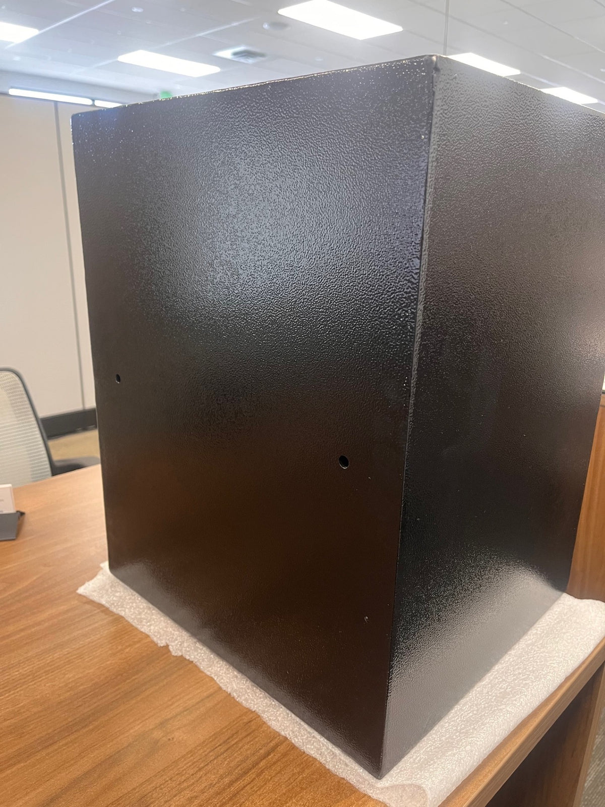 Back view of the safe. It has two predrilled holes on the back to mount it onto a wall. 