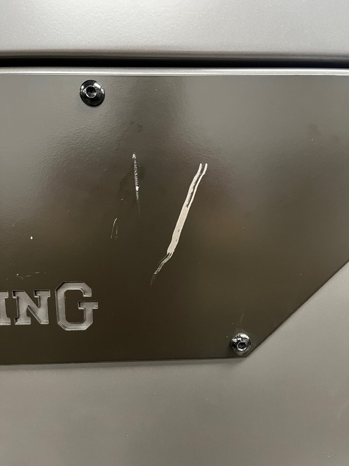 Close -up of a scratch on the Browning plate. 