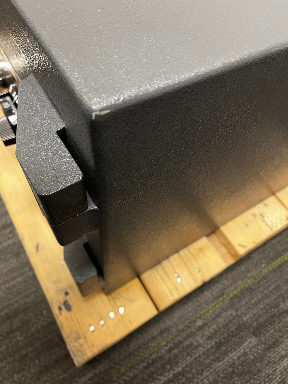 Close-up of the top right corner with a scratch. 