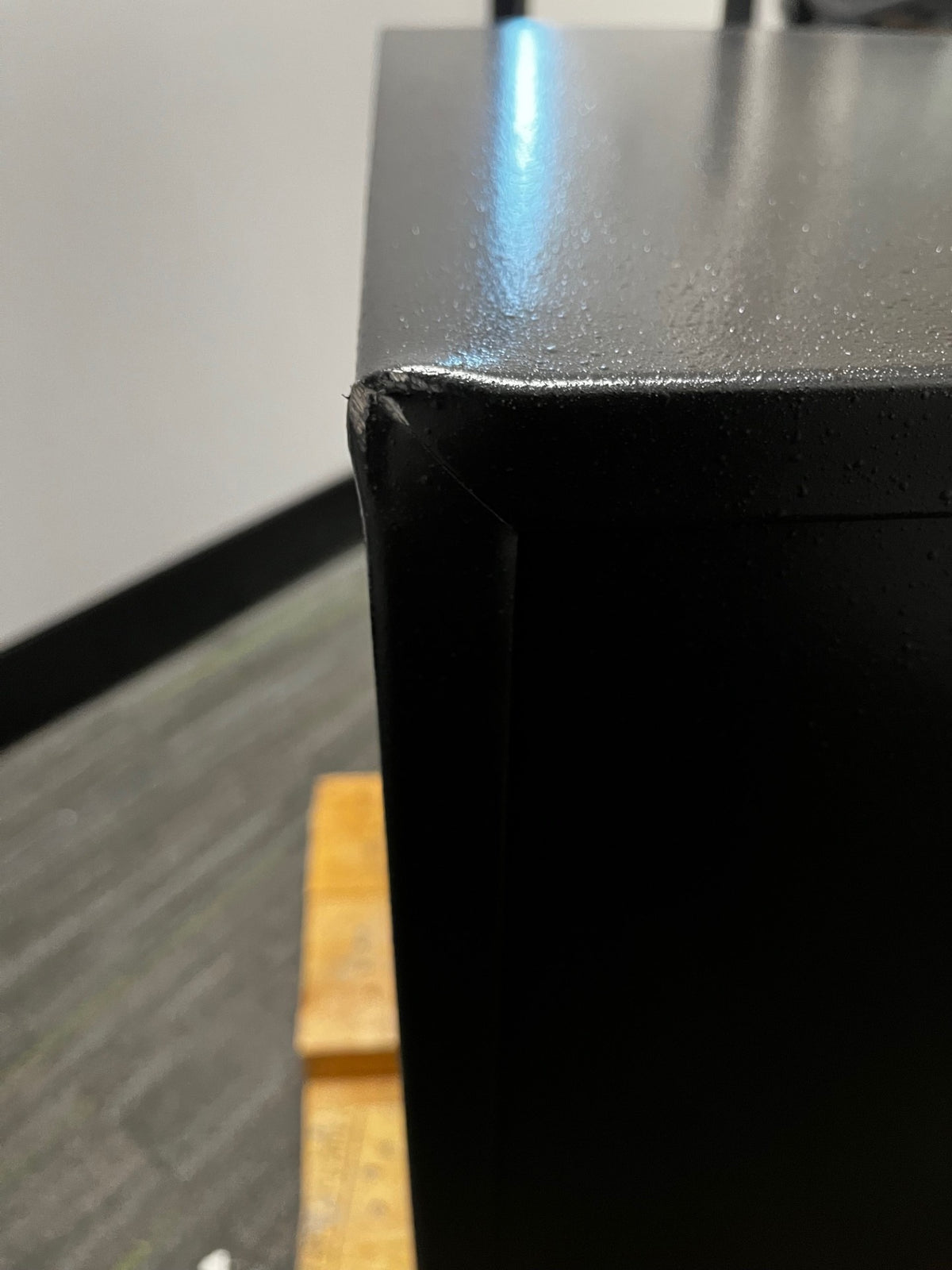 Has a scratch and dent on the back top left corner. 